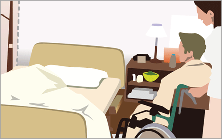 職員が車椅子の利用者を押しながらベッドまで移動している