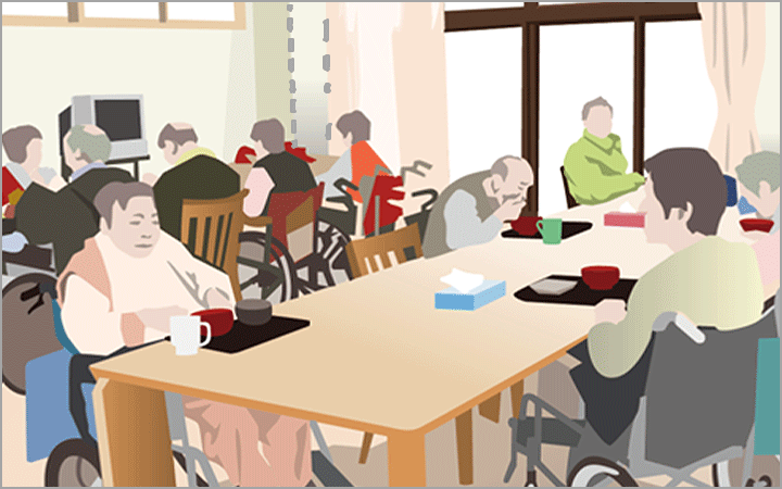 食堂で大人数の利用者が食事をしている